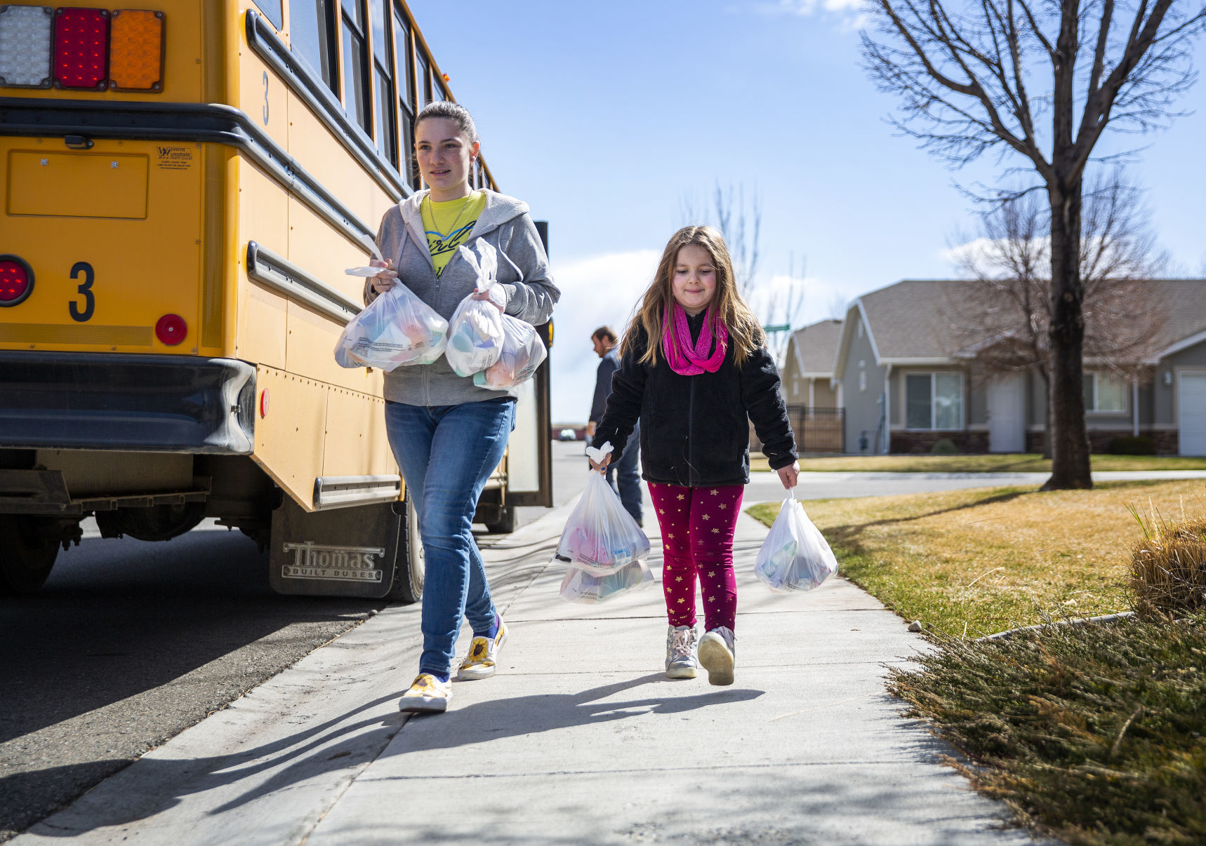 Bus drivers deliver food to students